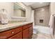 A modern bathroom featuring stylish tile work, granite countertops, and a shower-tub combo at 9340 N 92Nd St # 120, Scottsdale, AZ 85258