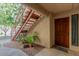 Building entryway with stairs leading to upper units and a private front door at 9340 N 92Nd St # 120, Scottsdale, AZ 85258