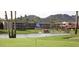 Scenic golf course with mature trees, lake, and mountain views, perfect for outdoor recreation at 9340 N 92Nd St # 120, Scottsdale, AZ 85258