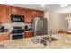 Updated kitchen with stainless appliances, granite counters, and cherry wood cabinets at 9340 N 92Nd St # 120, Scottsdale, AZ 85258