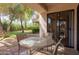 This patio features outdoor seating, an upper balcony, and lush foliage at 9340 N 92Nd St # 120, Scottsdale, AZ 85258