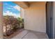 This patio features outdoor foliage, a clean cement floor, and a metal framed door at 9340 N 92Nd St # 120, Scottsdale, AZ 85258