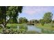Picturesque pond surrounded by lush greenery and mature trees providing a beautiful, tranquil environment at 9340 N 92Nd St # 120, Scottsdale, AZ 85258