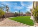 Expansive backyard featuring lush artificial turf, desert landscaping, and ample space for outdoor activities at 1085 W Ayrshire Trl, San Tan Valley, AZ 85143