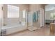 Bright bathroom featuring a soaking tub, seamless glass shower, tile flooring and natural lighting at 1085 W Ayrshire Trl, San Tan Valley, AZ 85143