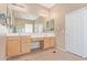Large primary bathroom with double sinks, framed mirror, and a walk-in shower behind glass blocks at 1085 W Ayrshire Trl, San Tan Valley, AZ 85143