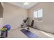 Bright home gym with carpeted floors, natural lighting, ceiling fan and access to equipment at 1085 W Ayrshire Trl, San Tan Valley, AZ 85143
