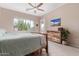 Bright bedroom featuring neutral walls, plush carpeting, a ceiling fan and view of desert landscaping at 1085 W Ayrshire Trl, San Tan Valley, AZ 85143