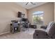 Home office featuring a large desk, multiple monitors, comfortable seating, and natural lighting at 1085 W Ayrshire Trl, San Tan Valley, AZ 85143