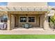 A covered patio has tile flooring and is furnished with a table and four chairs, creating an inviting outdoor space at 1085 W Ayrshire Trl, San Tan Valley, AZ 85143