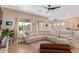 Spacious living room with a comfortable sectional sofa and views into the backyard at 1085 W Ayrshire Trl, San Tan Valley, AZ 85143