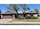 Charming single-story brick home featuring a mature tree and well-manicured front yard at 11038 N 53Rd Dr, Glendale, AZ 85304
