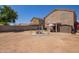 Expansive backyard featuring a metal pergola, covered patio, storage shed, and ample space for outdoor activities at 12517 W Santa Fe Ln, El Mirage, AZ 85335
