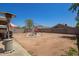 Spacious backyard with patio area, outdoor grill, metal pergola, and plenty of room for outdoor entertaining at 12517 W Santa Fe Ln, El Mirage, AZ 85335