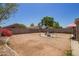 Large backyard with a gravel surface featuring a gazebo at 12517 W Santa Fe Ln, El Mirage, AZ 85335