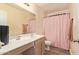 Bathroom with vanity, sink, and a shower with a pink shower curtain at 12517 W Santa Fe Ln, El Mirage, AZ 85335