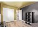 Bedroom featuring sliding closet doors and a dark accent wall at 12517 W Santa Fe Ln, El Mirage, AZ 85335