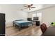 Bedroom with light wood flooring, ceiling fan, and a window with natural light at 12517 W Santa Fe Ln, El Mirage, AZ 85335