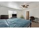 Bright bedroom with wood floors, ceiling fan, and ample natural light from the window at 12517 W Santa Fe Ln, El Mirage, AZ 85335