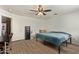 Spacious bedroom with hardwood floors, ceiling fan, and a safe for valuables at 12517 W Santa Fe Ln, El Mirage, AZ 85335