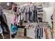 Walk-in closet with plenty of storage shelves and clothing racks at 12517 W Santa Fe Ln, El Mirage, AZ 85335