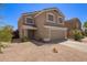Charming home exterior with a two-car garage, easy care gravel yard, and lush green landscaping at 12517 W Santa Fe Ln, El Mirage, AZ 85335