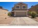 Home exterior showing a two-car garage, low-maintenance landscaping, and a freshly paved driveway at 12517 W Santa Fe Ln, El Mirage, AZ 85335