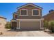 Two-story home with neutral colored stucco and a two car garage at 12517 W Santa Fe Ln, El Mirage, AZ 85335