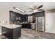 Kitchen with stainless steel appliances and black cabinets at 12517 W Santa Fe Ln, El Mirage, AZ 85335