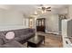 Cozy living room with wood floors, a comfortable sectional, and a classic china cabinet at 12517 W Santa Fe Ln, El Mirage, AZ 85335