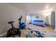 Bright spare bedroom with a daybed, modern lighting and an exercise bike at 1425 E Desert Cove Ave # 35, Phoenix, AZ 85020
