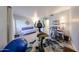 Bright bonus room with daybed, home office desk, exercise bike, and blue yoga ball at 1425 E Desert Cove Ave # 35, Phoenix, AZ 85020