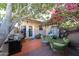 Cozy outdoor patio with mature plants, a grill, and seating area at 1425 E Desert Cove Ave # 35, Phoenix, AZ 85020