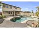 Relax in your backyard with this beautiful pool, covered patio, and mature desert landscaping at 14754 W Amelia Ave, Goodyear, AZ 85395