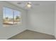 Bright bedroom featuring neutral walls, plush carpet, a ceiling fan and a window with horizontal blinds at 14754 W Amelia Ave, Goodyear, AZ 85395