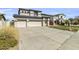Charming home featuring a three-car garage, large driveway, solar panels, and desert landscaping at 14754 W Amelia Ave, Goodyear, AZ 85395
