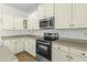 Kitchen featuring stainless steel appliances, granite countertops, and abundant white cabinetry at 14754 W Amelia Ave, Goodyear, AZ 85395