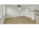 Bright living room with wood floors, plantation shutters, and a ceiling fan at 14754 W Amelia Ave, Goodyear, AZ 85395