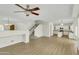 Open-concept living room flows into the kitchen, featuring stairs and wood-look flooring at 14754 W Amelia Ave, Goodyear, AZ 85395