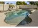 The backyard features a freeform pool, rock waterfall, and mature landscaping, perfect for entertaining at 14754 W Amelia Ave, Goodyear, AZ 85395