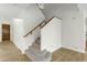 Carpeted staircase with wood railing and a white wall at 14754 W Amelia Ave, Goodyear, AZ 85395