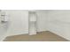 A simple walk-in closet with shelving and carpeted floor at 14754 W Amelia Ave, Goodyear, AZ 85395