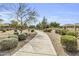 Community walking path, with desert landscaping, gravel, and bushes at 14754 W Amelia Ave, Goodyear, AZ 85395