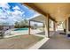 A covered patio overlooks the backyard, with views of the pool and a spacious yard for outdoor activities at 1517 E Elaine Dr, Casa Grande, AZ 85122
