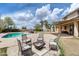 This backyard features a pool, fire pit, outdoor seating, and plenty of space for recreation and relaxation at 1517 E Elaine Dr, Casa Grande, AZ 85122