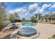 This backyard offers a pool, hot tub, and seating area, creating a relaxing outdoor retreat at 1517 E Elaine Dr, Casa Grande, AZ 85122
