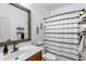 Bathroom featuring a new vanity, framed mirror, and decorative shower curtain at 1517 E Elaine Dr, Casa Grande, AZ 85122
