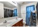 This bathroom has a double sink vanity, mirror, toilet, and tiled floors at 1517 E Elaine Dr, Casa Grande, AZ 85122
