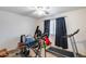 Bedroom features fitness equipment; treadmill, elliptical, chair and shelving unit by window with natural light at 1517 E Elaine Dr, Casa Grande, AZ 85122