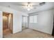 A bright, carpeted bedroom features a window and mirrored closet doors at 1517 E Elaine Dr, Casa Grande, AZ 85122